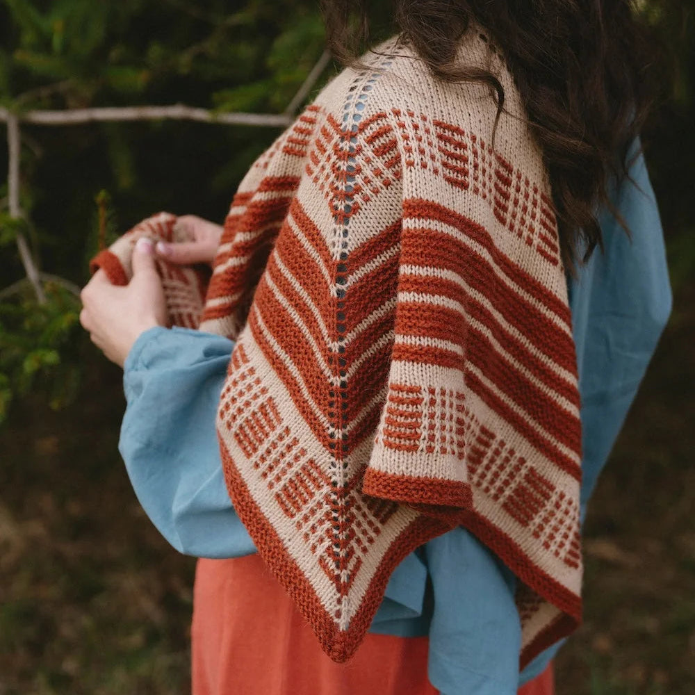 Person wearing a patterned shawl outdoors
